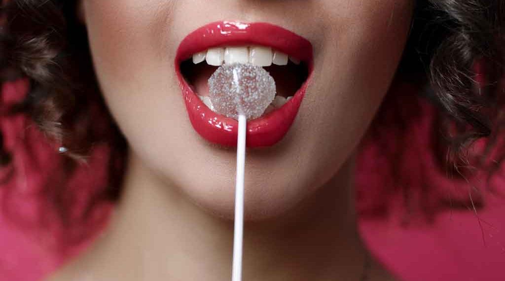 a Guyanse woman with red lips and a lollipop