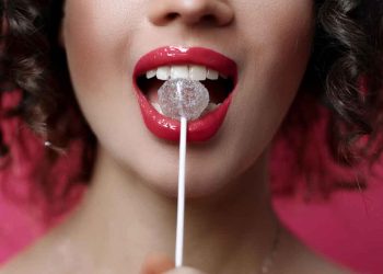 a Guyanse woman with red lips and a lollipop